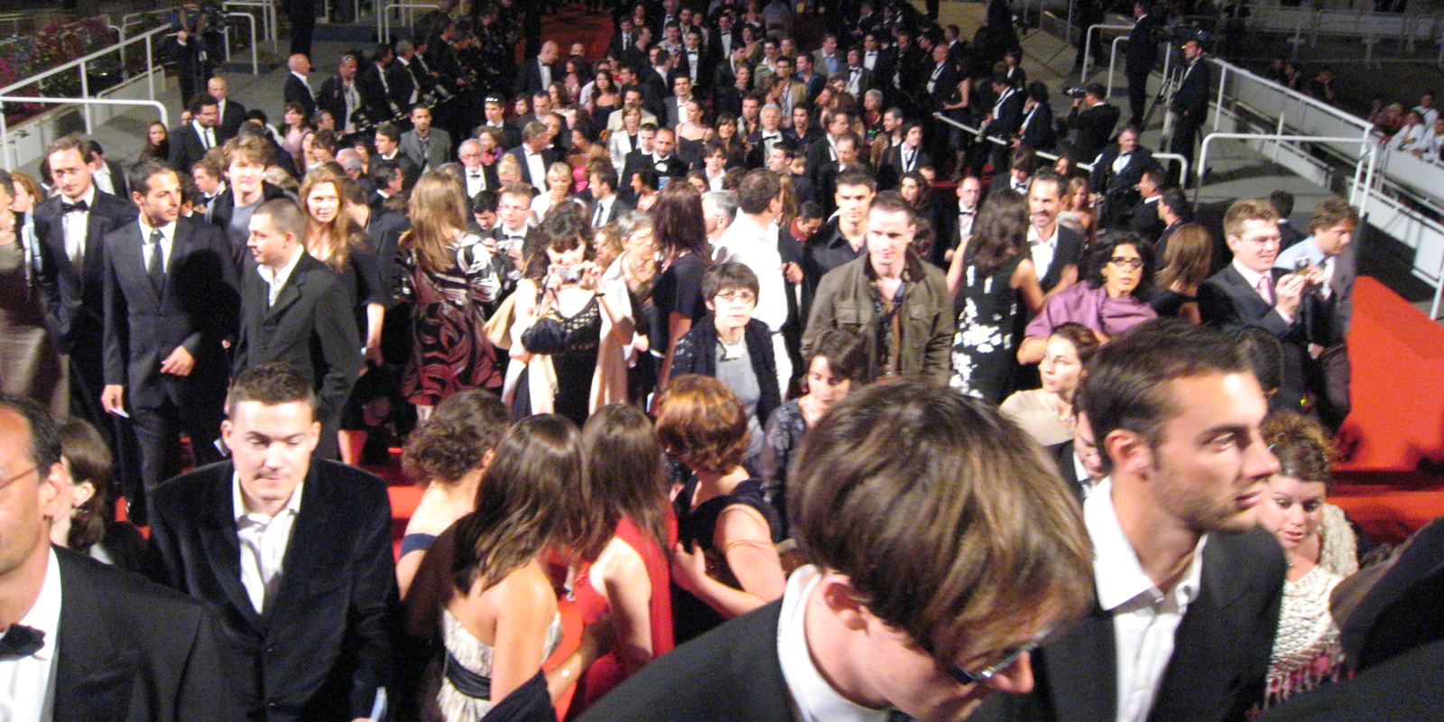 Crowds and photographers around the red carpet stairs at the Cannes Film Festival