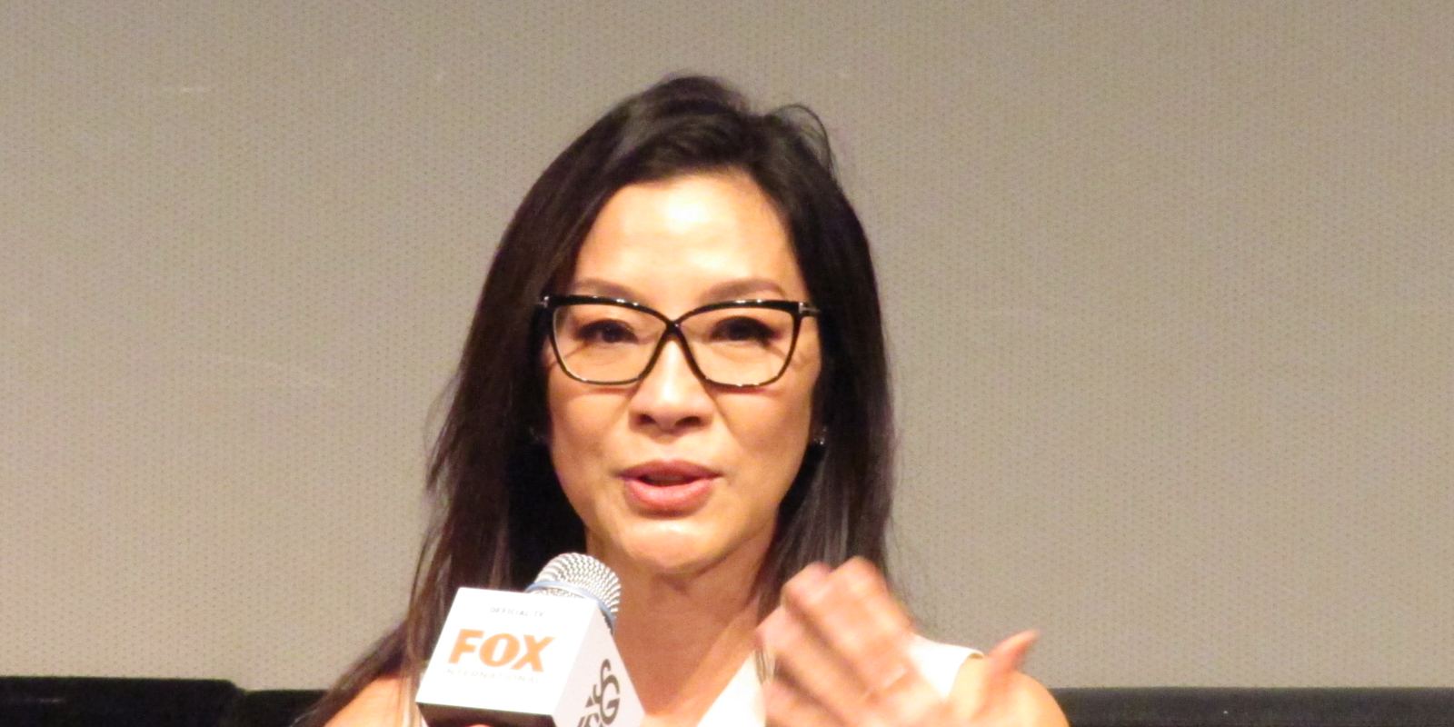 Michelle Yeoh speaking on stage at the Singapore International Film Festival in 2015