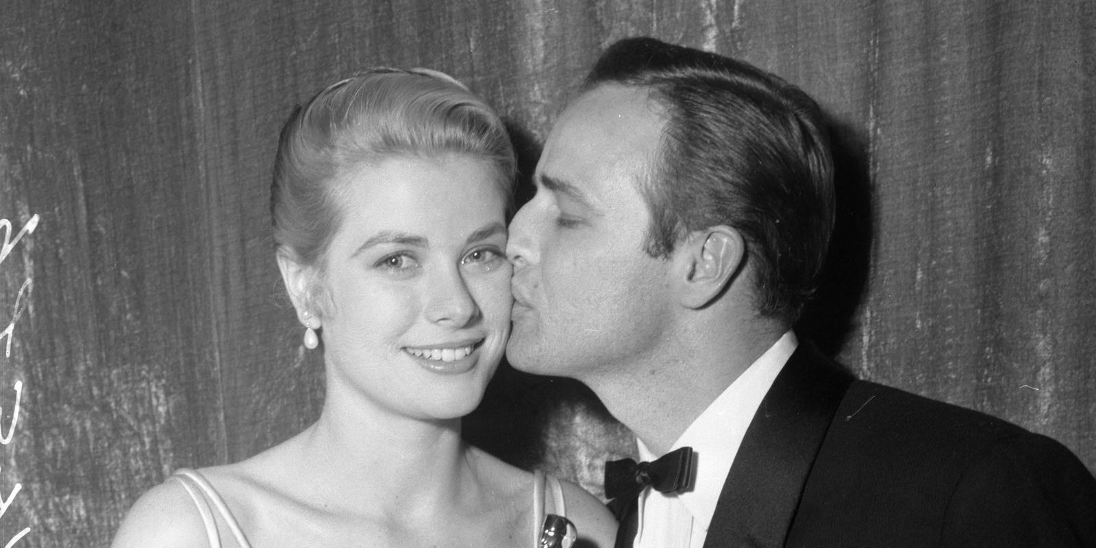 Grace Kelly and Marlon Brando holding their Oscars at the 1955 Academy Awards