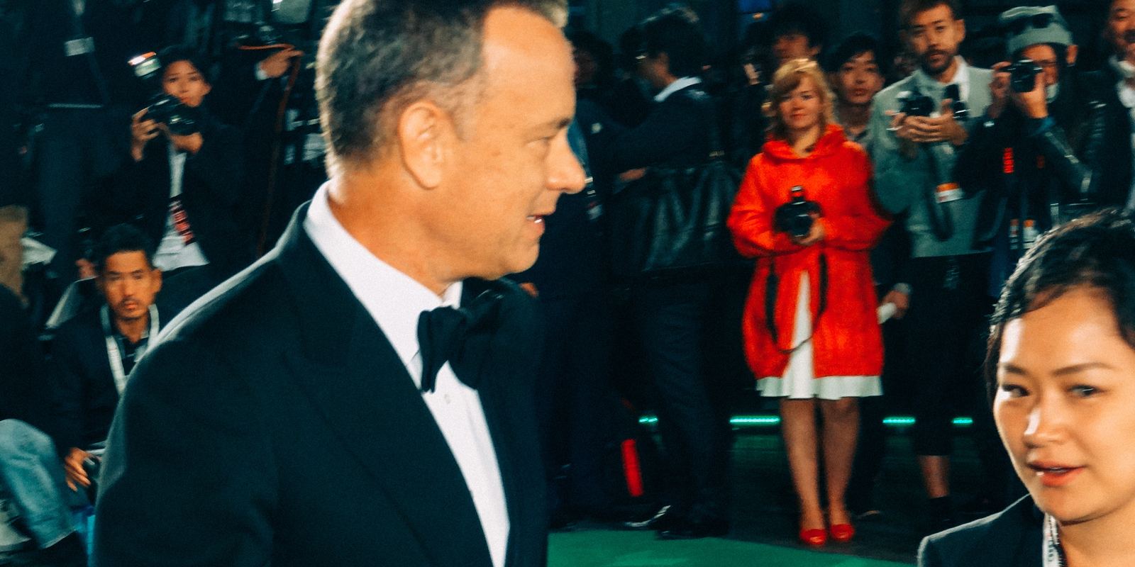 Tom Hanks waving on the green carpet at the Tokyo International Film Festival in 2013